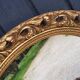 Round neoclassical style mirror in wood and gilded stucco from the 1950s