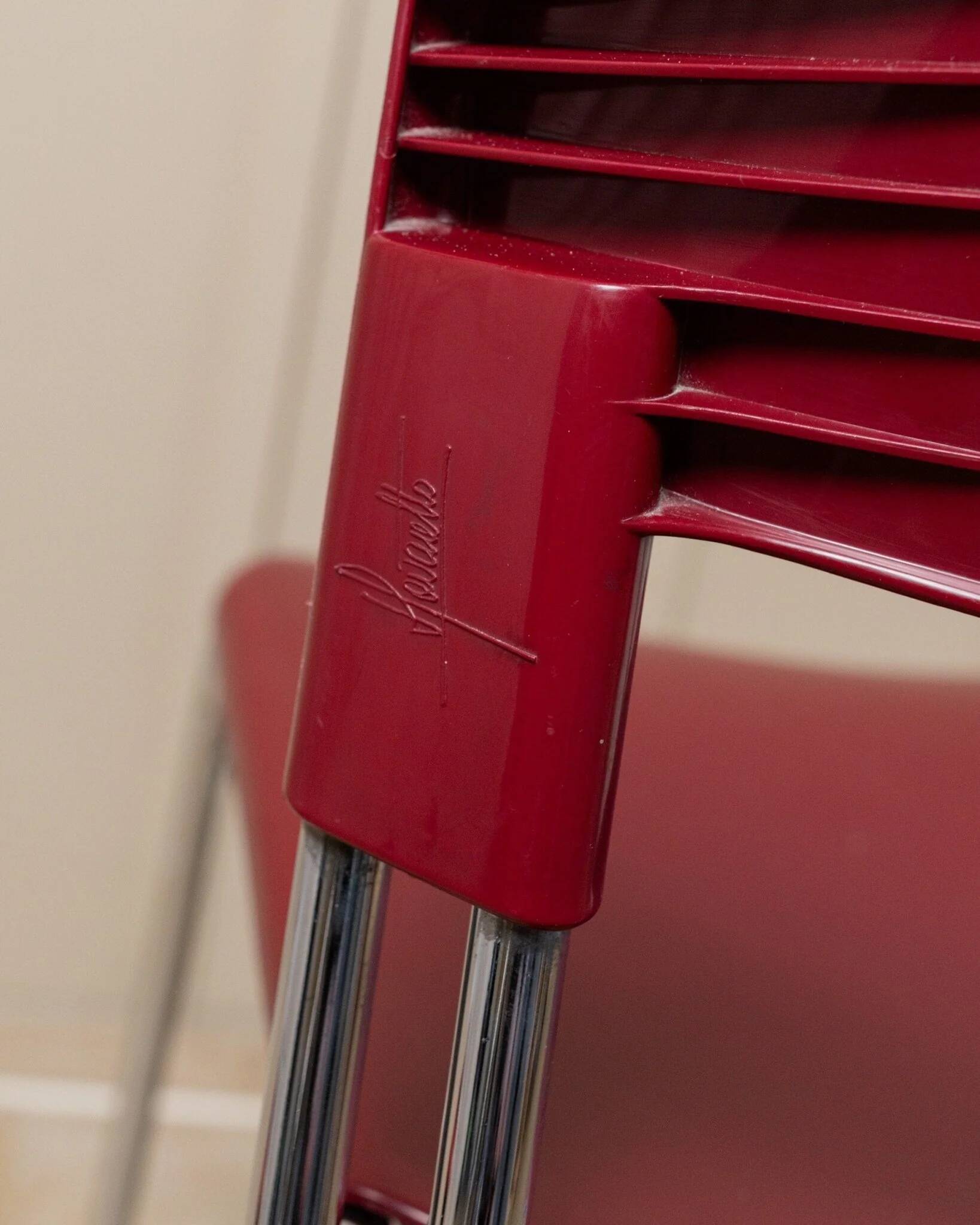 Red plastic-seat stacking chair with chrome frame by Paolo Favaretto for Assisa (Italy 1986) – vintage design