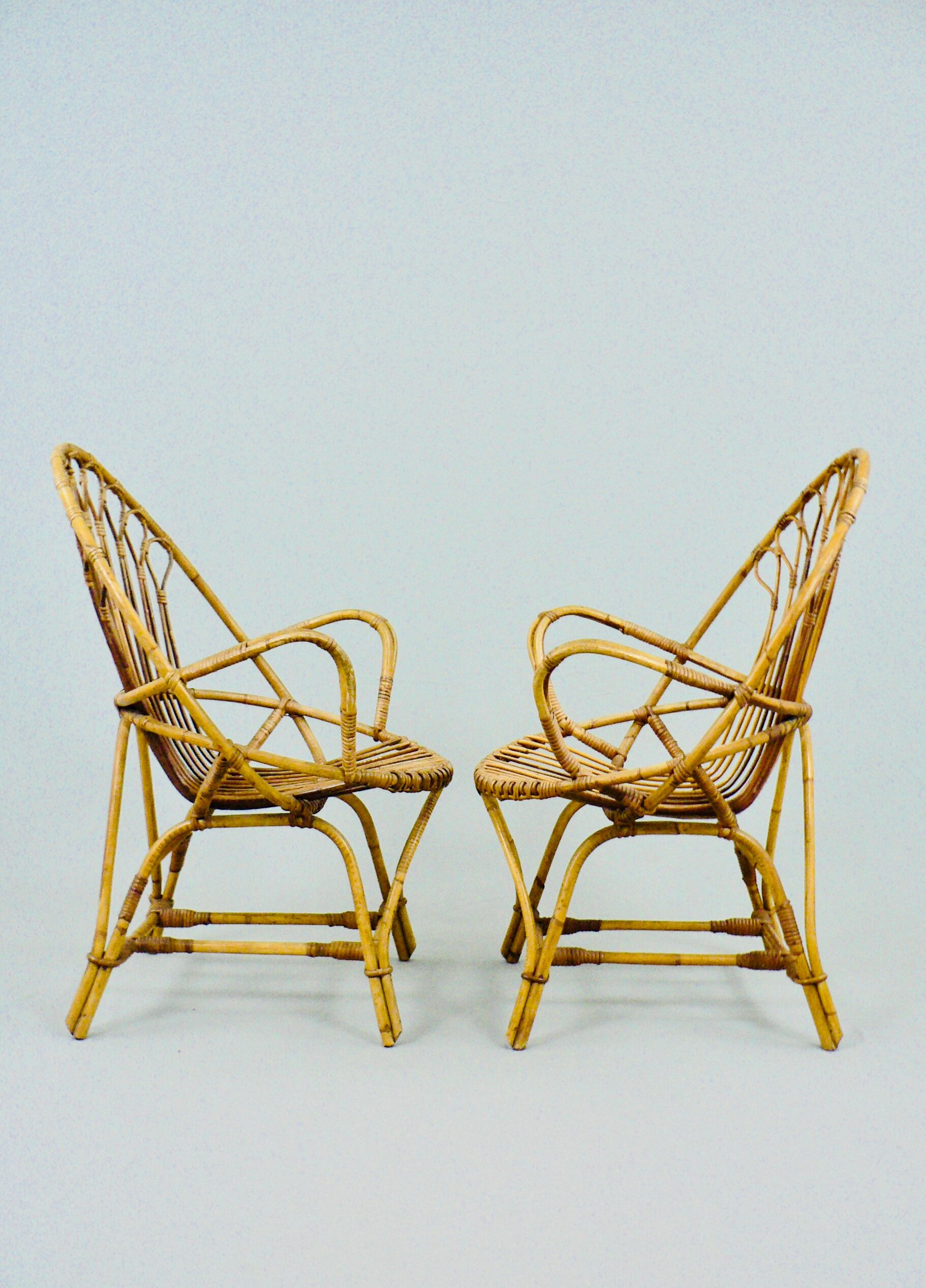A pair of rattan chairs