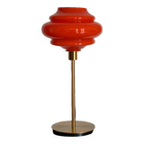 Table lamp with a vintage orange globe from an old pendant light