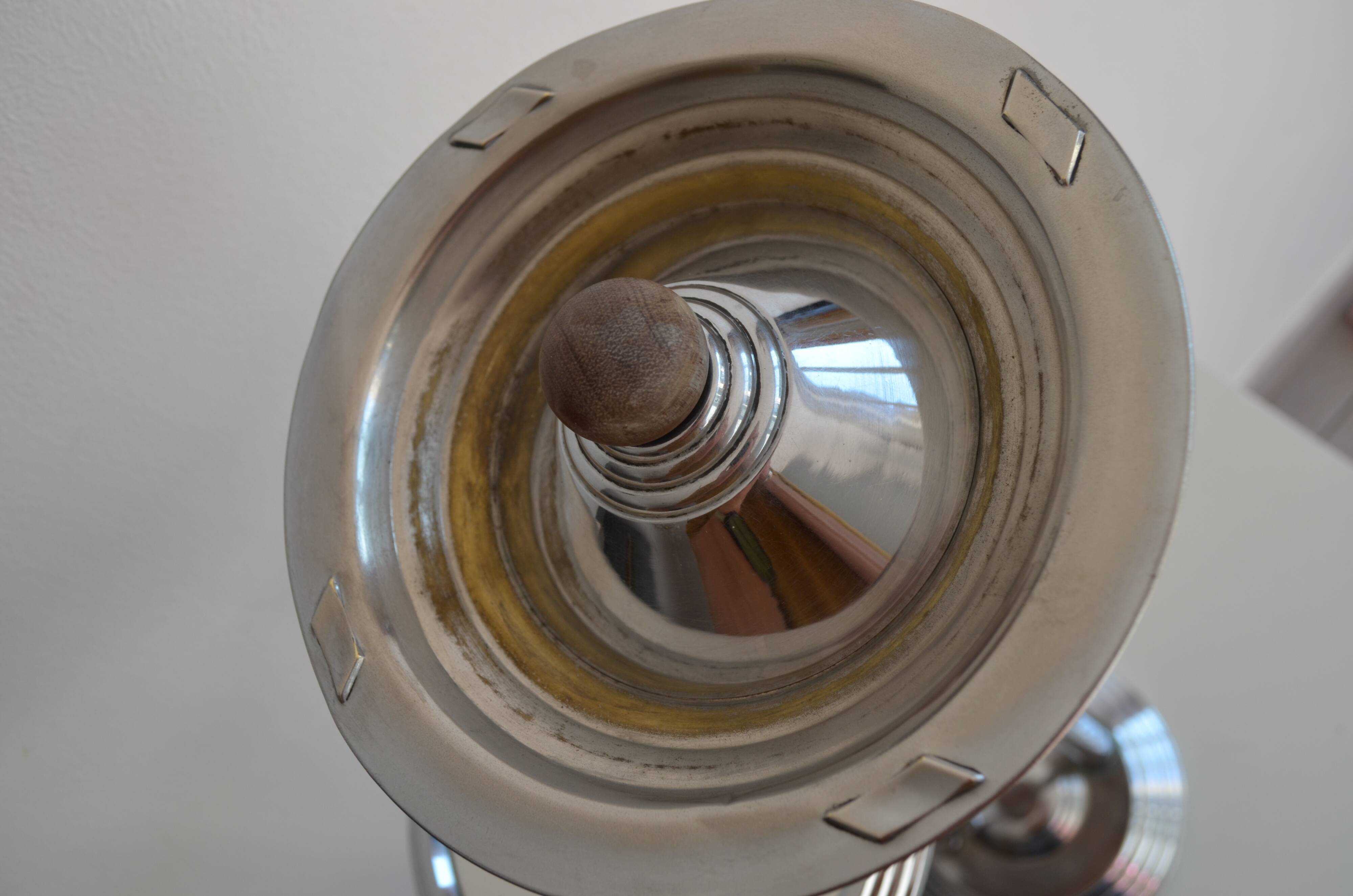 Ashtray and shelf on chrome metal stand.
