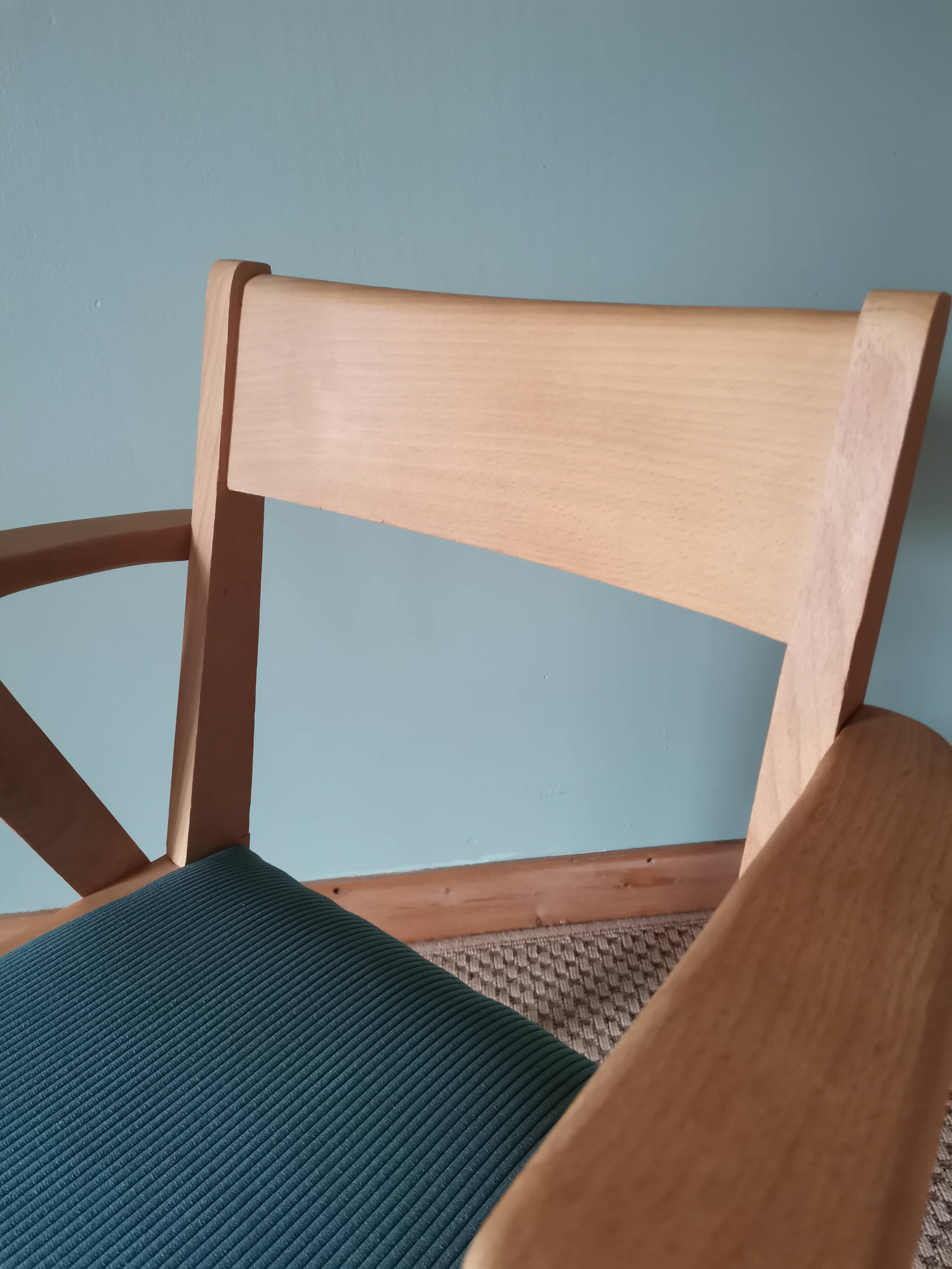 Scandinavian armchairs with green tapered legs.