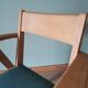 Scandinavian armchairs with green tapered legs.