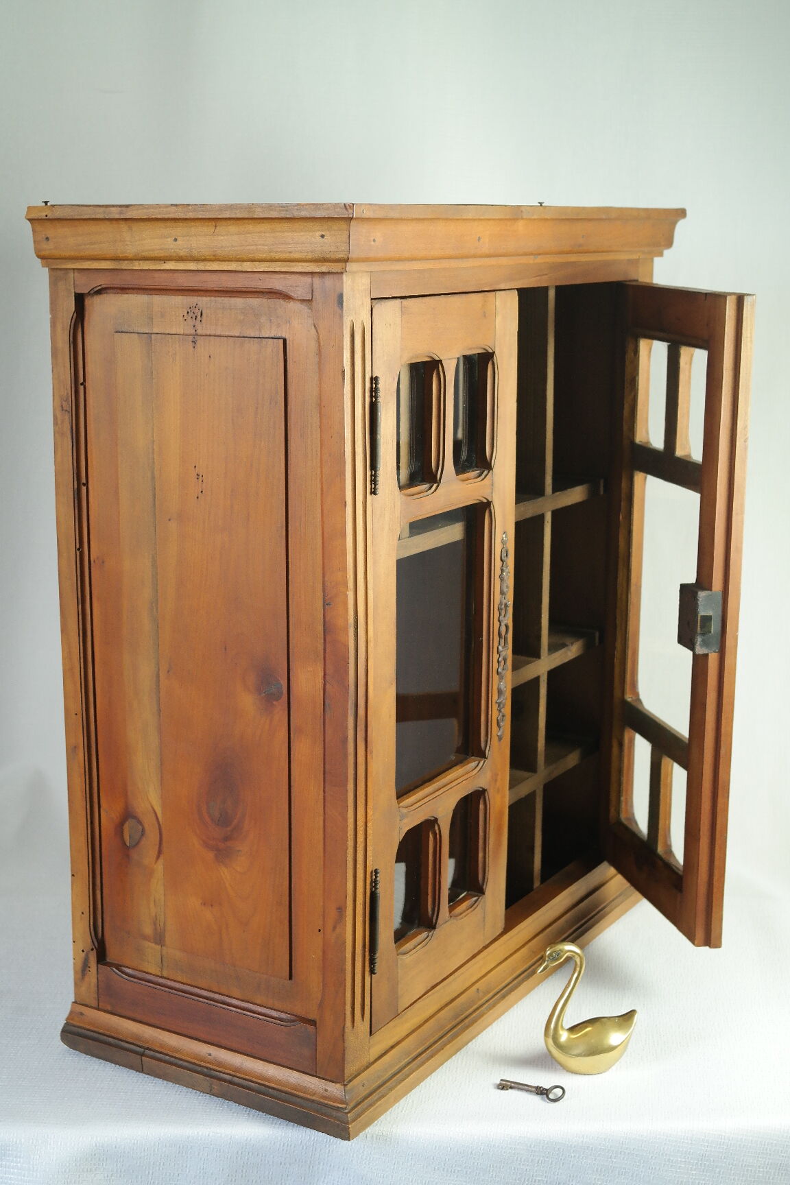 Antique walnut display cabinet from the 20th century.