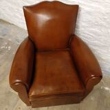 Antique club chair with mustache back