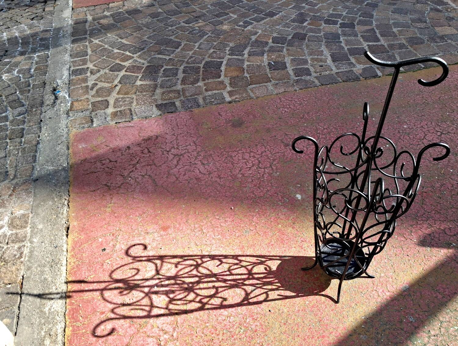 Antique wrought iron umbrella stand for entrance hall, vintage decor.