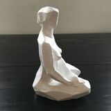 Statuette woman seated in plaster