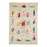 White suzani kilim rug with hand embroidered multi-colored patterns