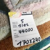 Hand-knotted wool rug by Tisca with a geometric pattern, signed "ILES", France, 1990s.