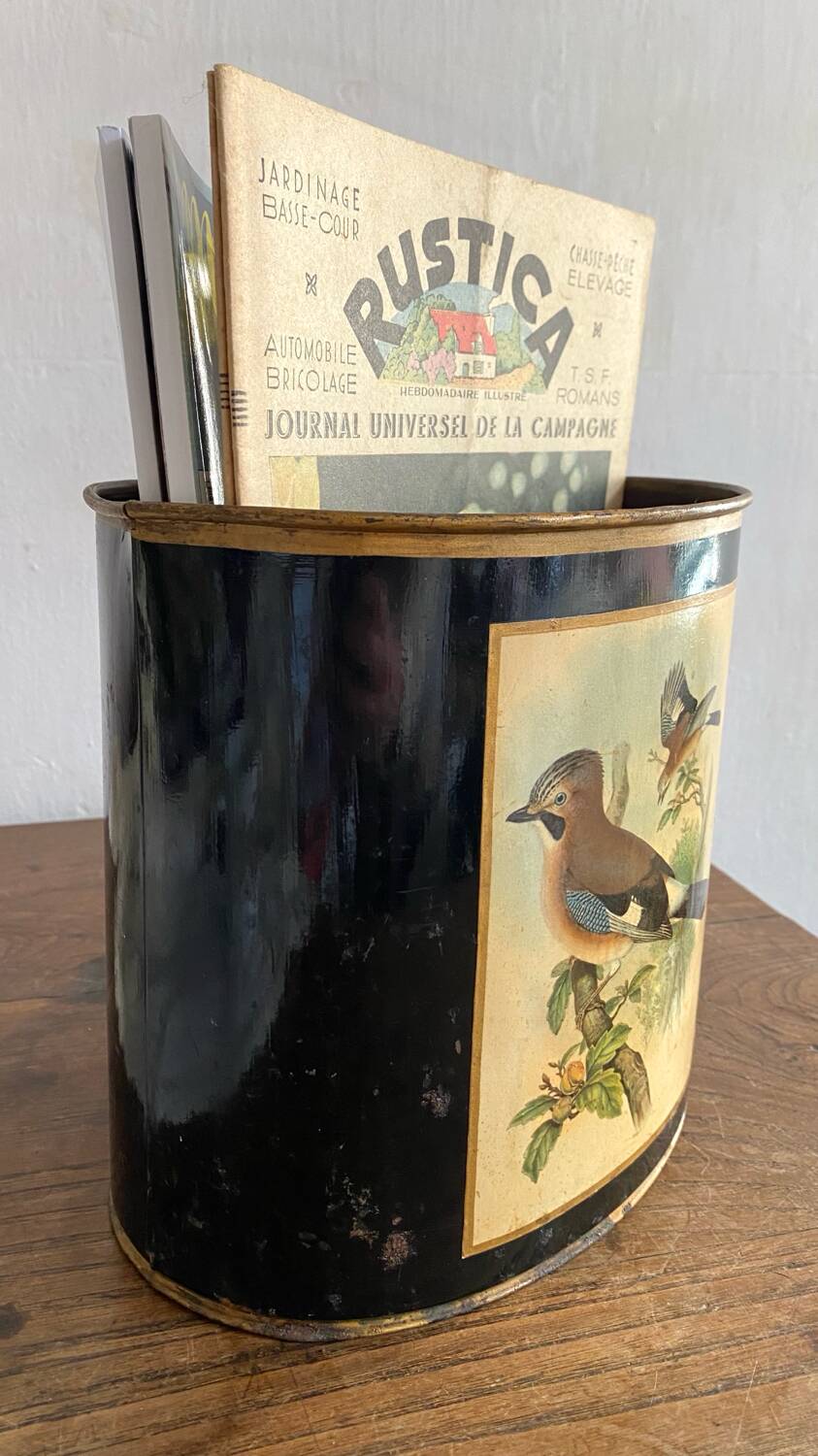 Metal wastebasket with bird decoration