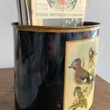 Metal wastebasket with bird decoration