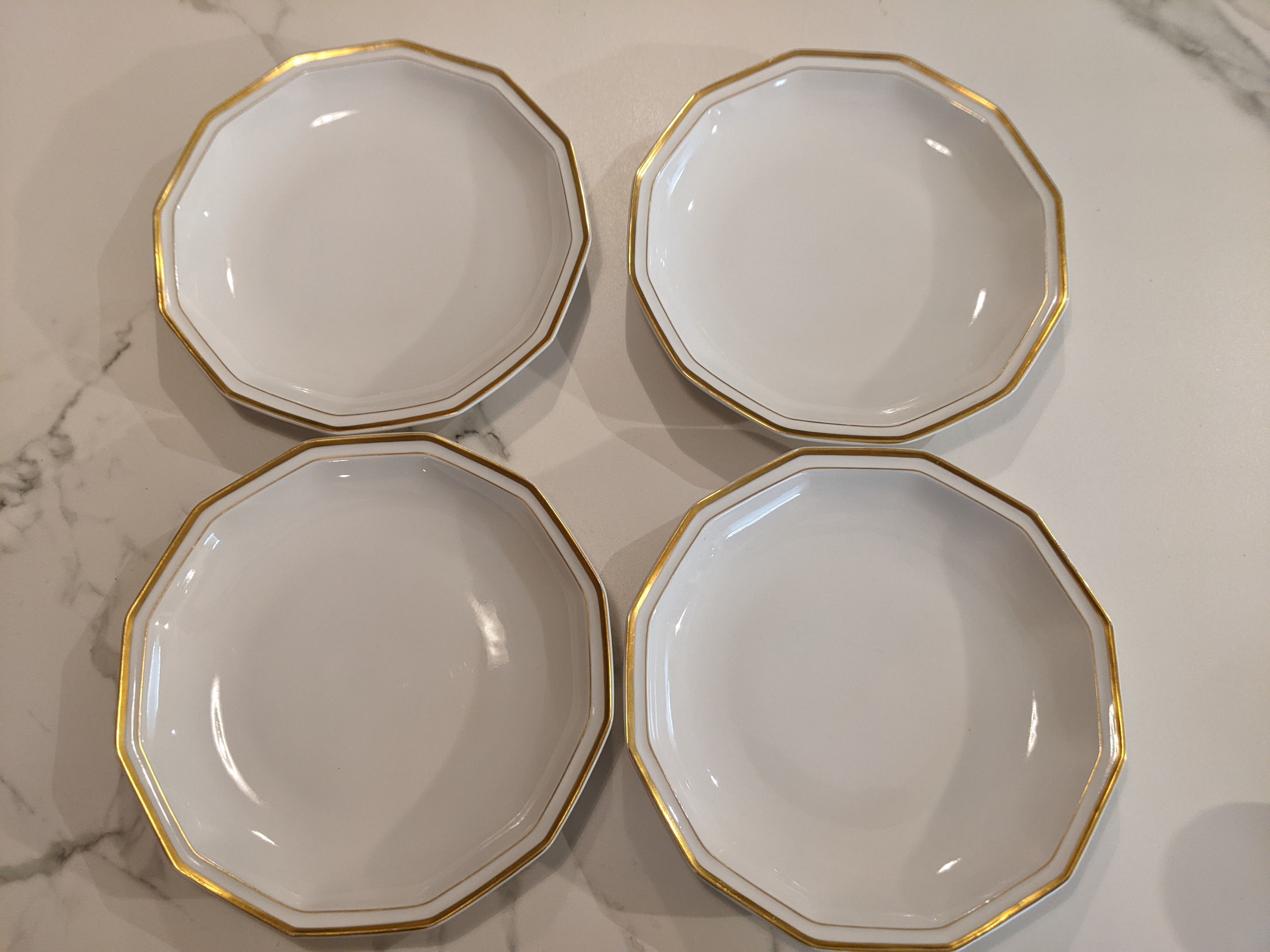 Set of vintage hollow plates in white and gilded Limoges porcelain