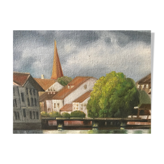 Painting on canvas of a village at the water's edge
