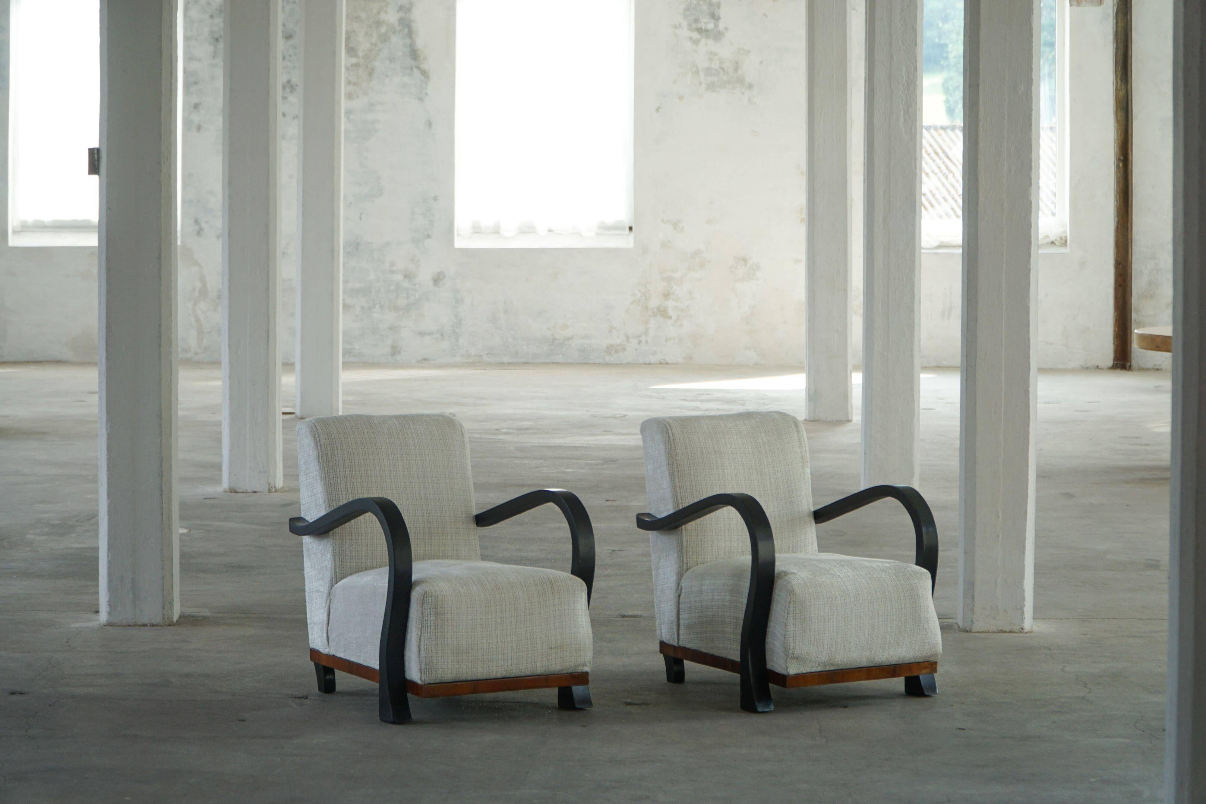 A pair of Swedish Art Deco lounge chairs with curved armrests, 1930s.