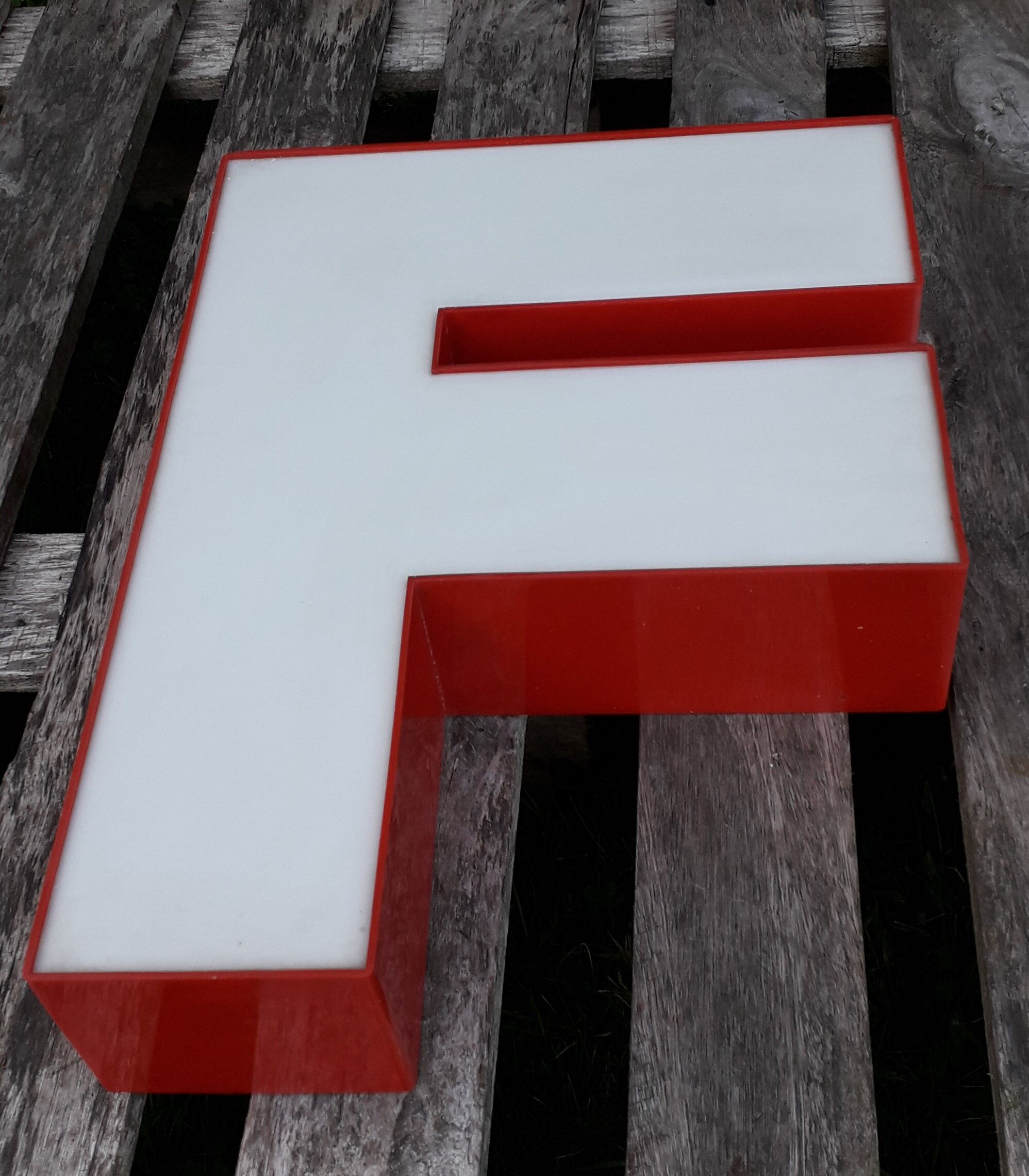 Red and white sign "f" letter