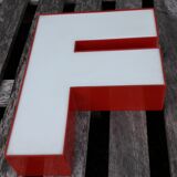 Red and white sign "f" letter