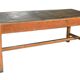 Large industrial workshop table in brown wood, wide top and sturdy vintage legs.