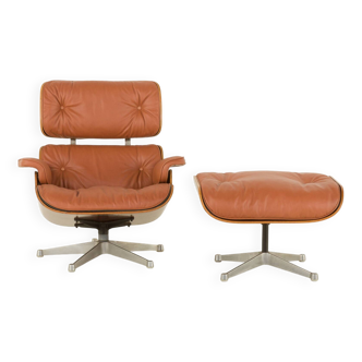 Lounge chair with aniline leather footstool, designed by Charles and Ray Eames