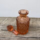 Art Deco perfume bottle in old amber pink glass