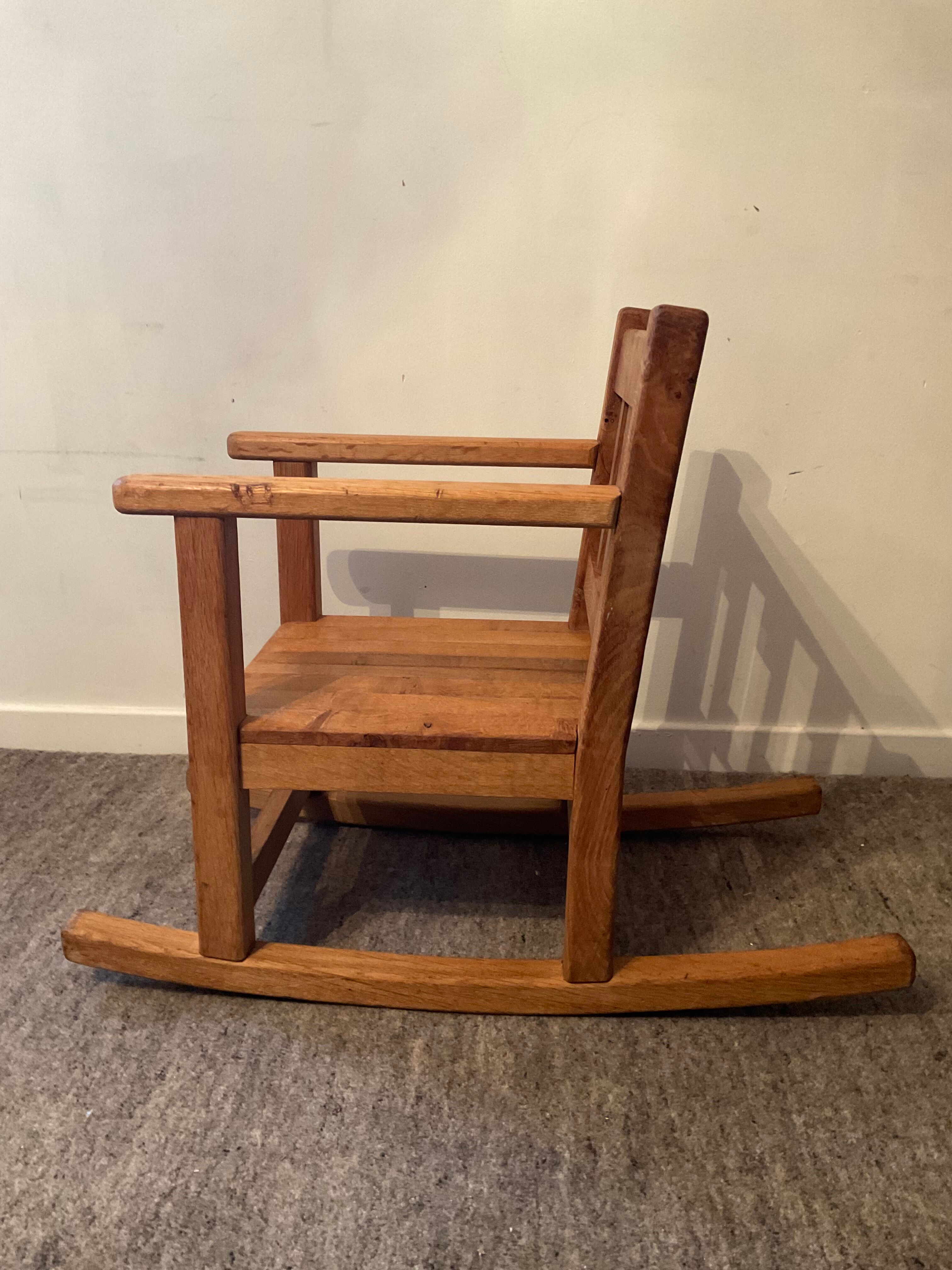 Old children's rocking chair in solid wood