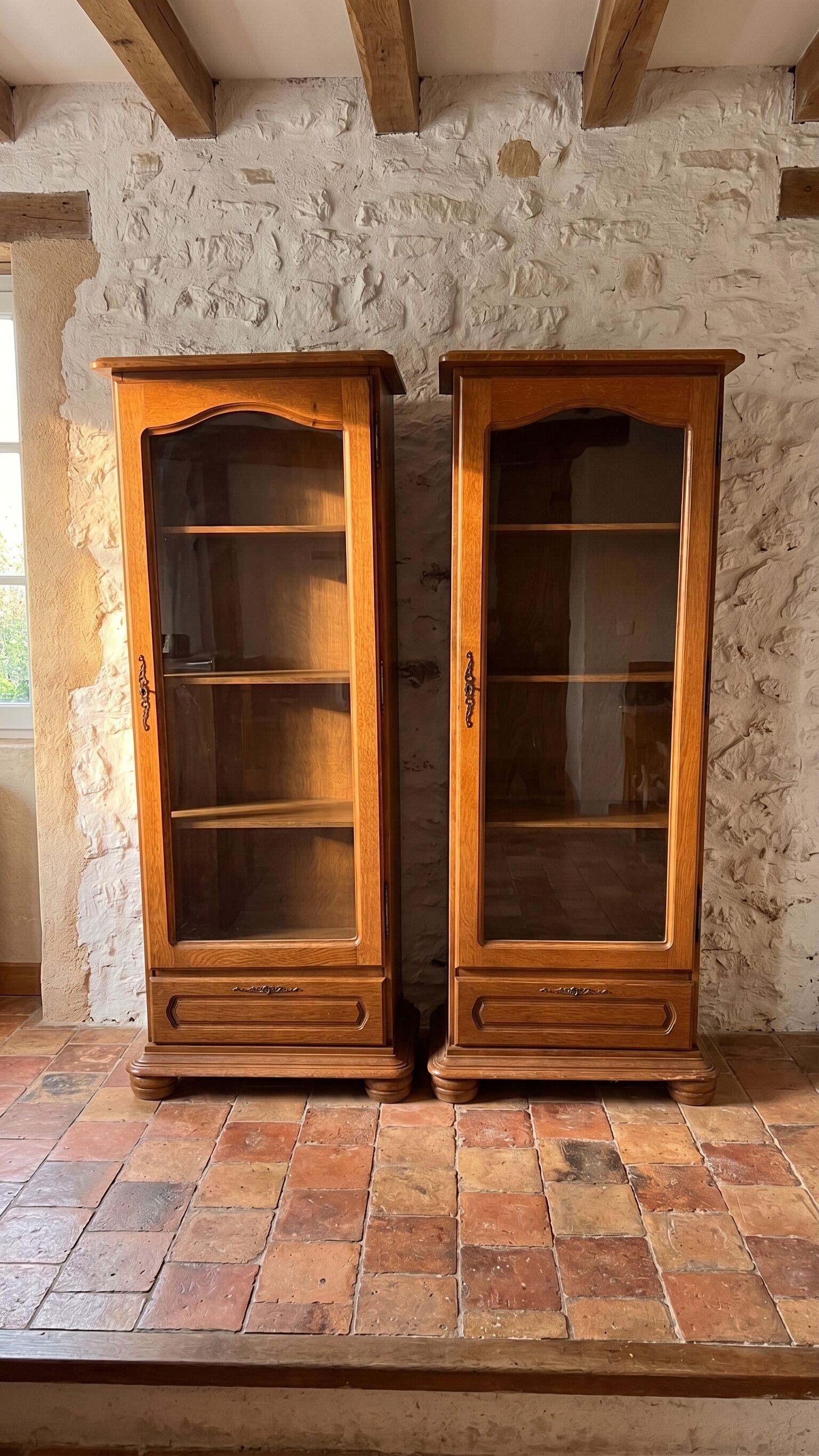 Set of 2 solid wood display cabinets with glass doors.
