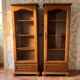 Set of 2 solid wood display cabinets with glass doors.