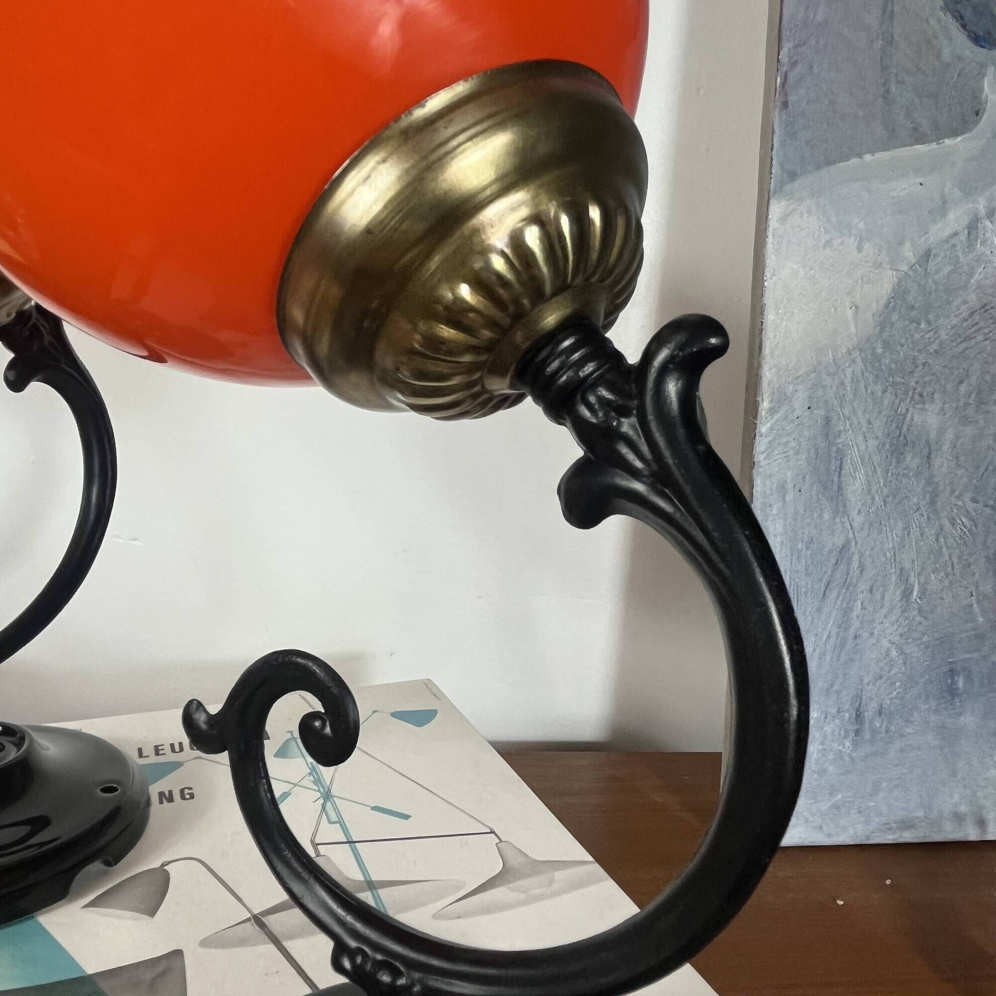 Pair of wall sconces with orange opaline globes and porcelain rose.