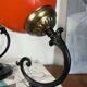 Pair of wall sconces with orange opaline globes and porcelain rose.