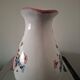 Old ceramic pitcher with floral decoration.