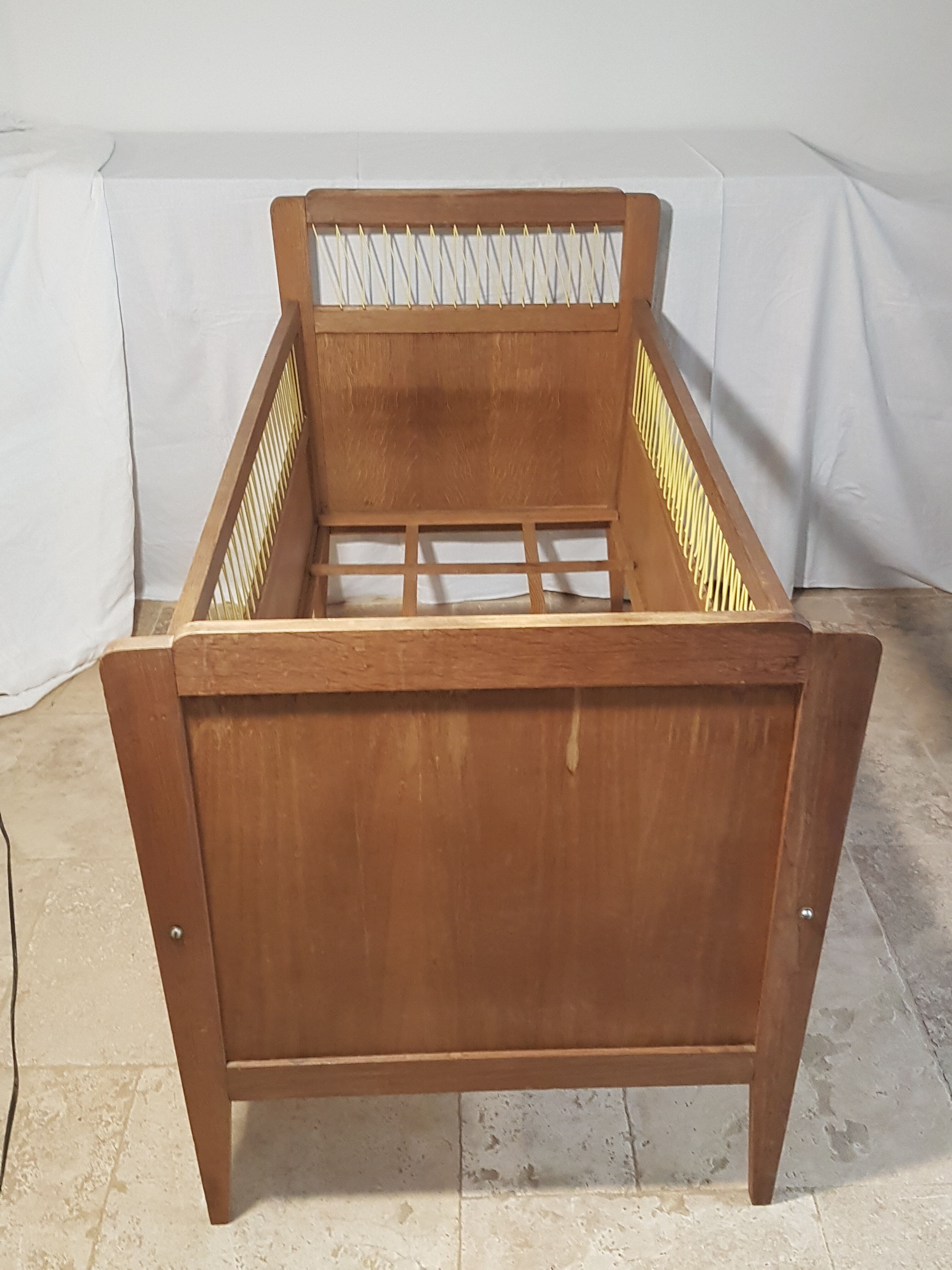 Children's bed made of wood and yellow scoubidou, 1950s.