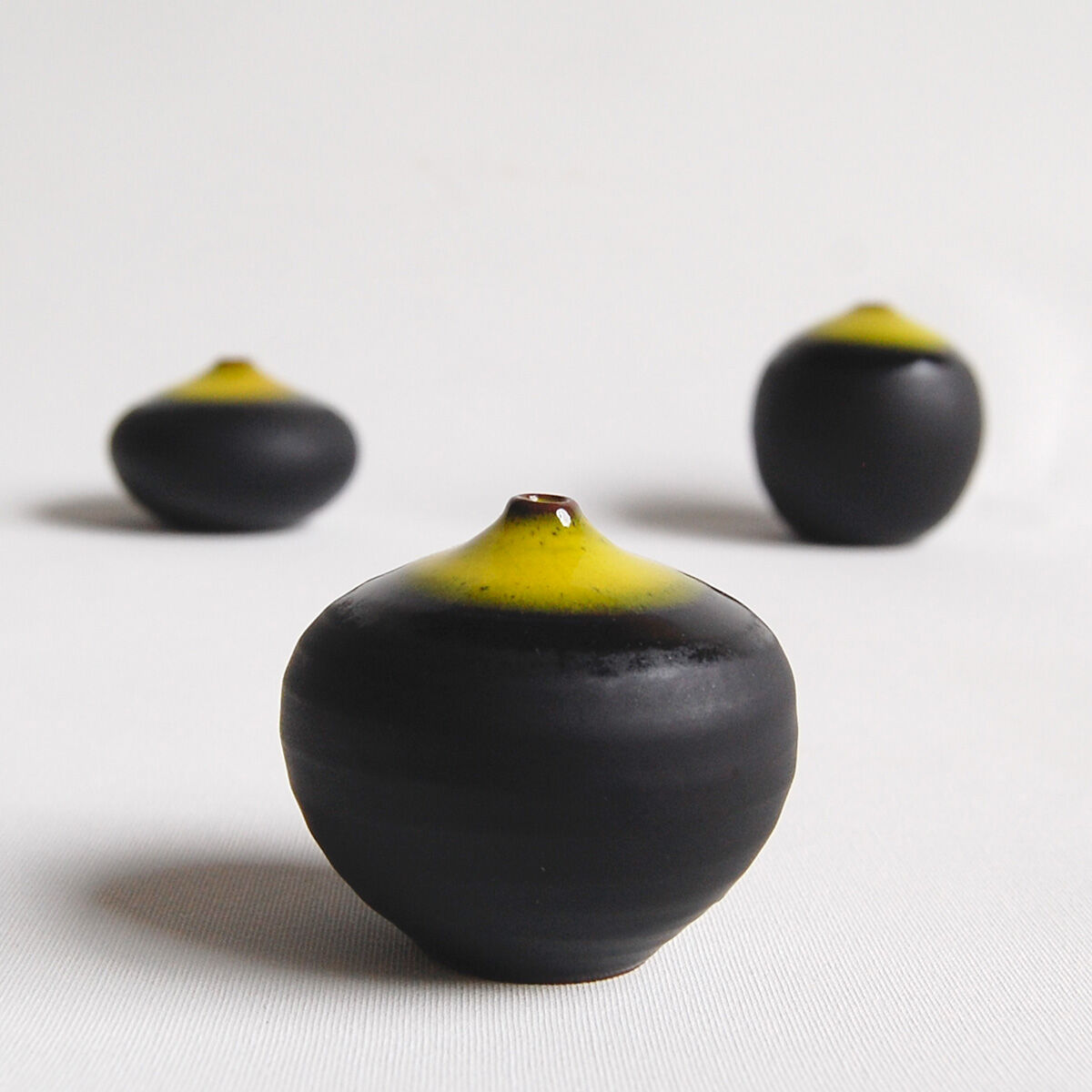 Trio of black and yellow miniature ceramics Antonio Lampecco