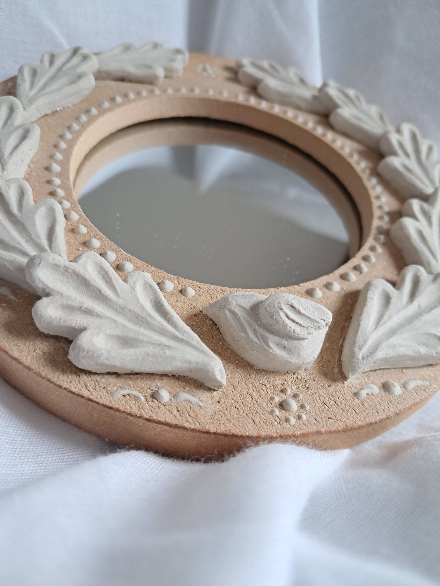 Red and white stoneware mirror, oak leaves