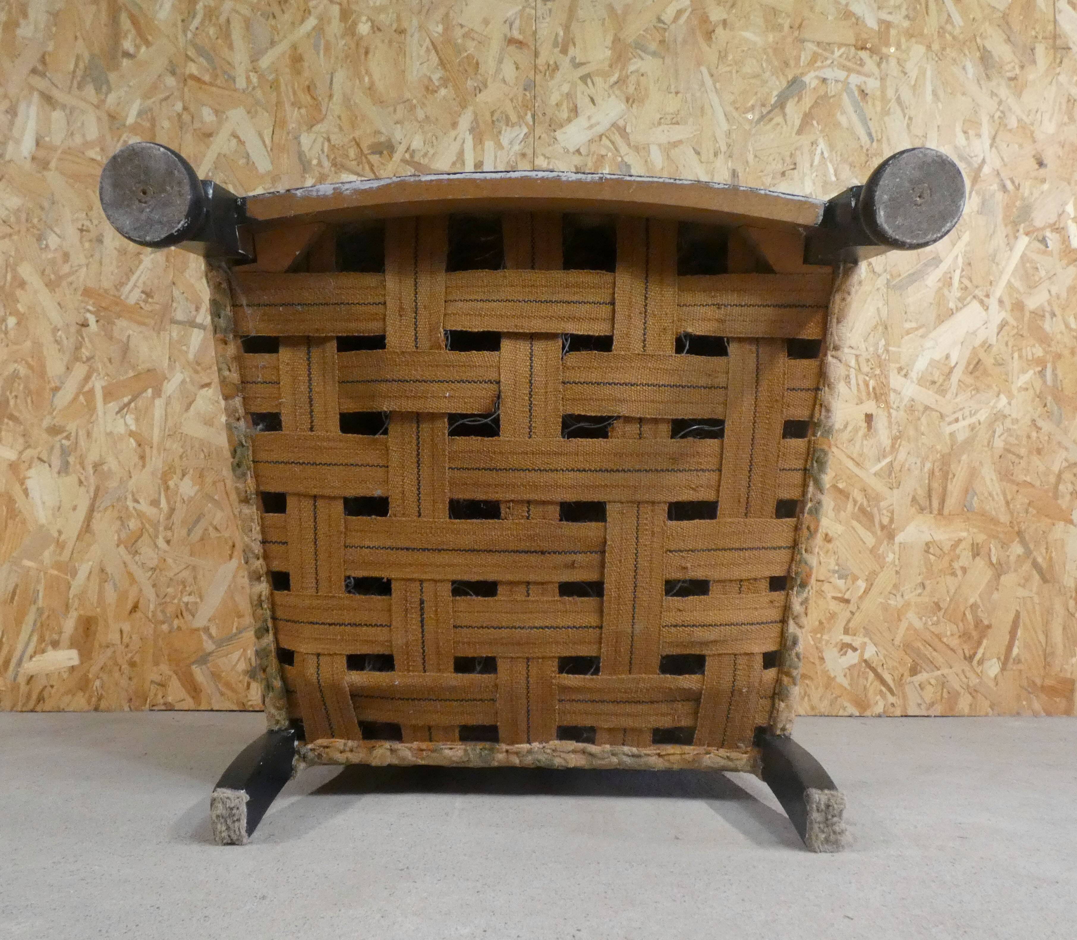 Old armchair upholstered in velvet, carved and caned wood