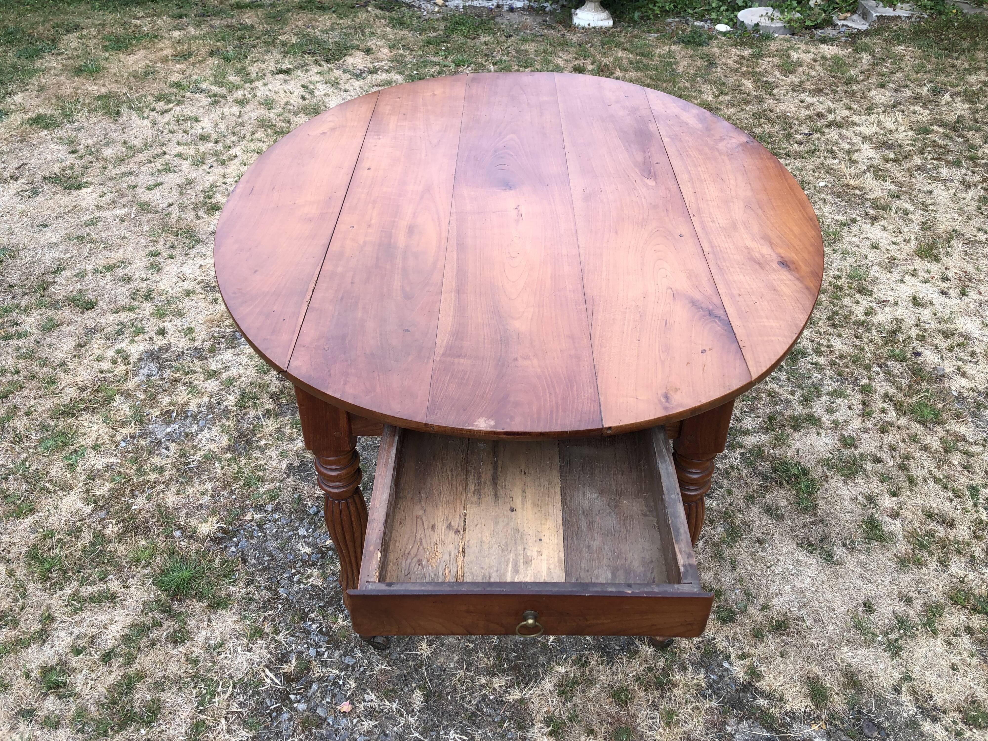 Louis Philippe oval drop-leaf table in solid cherry wood with 2 drawers.