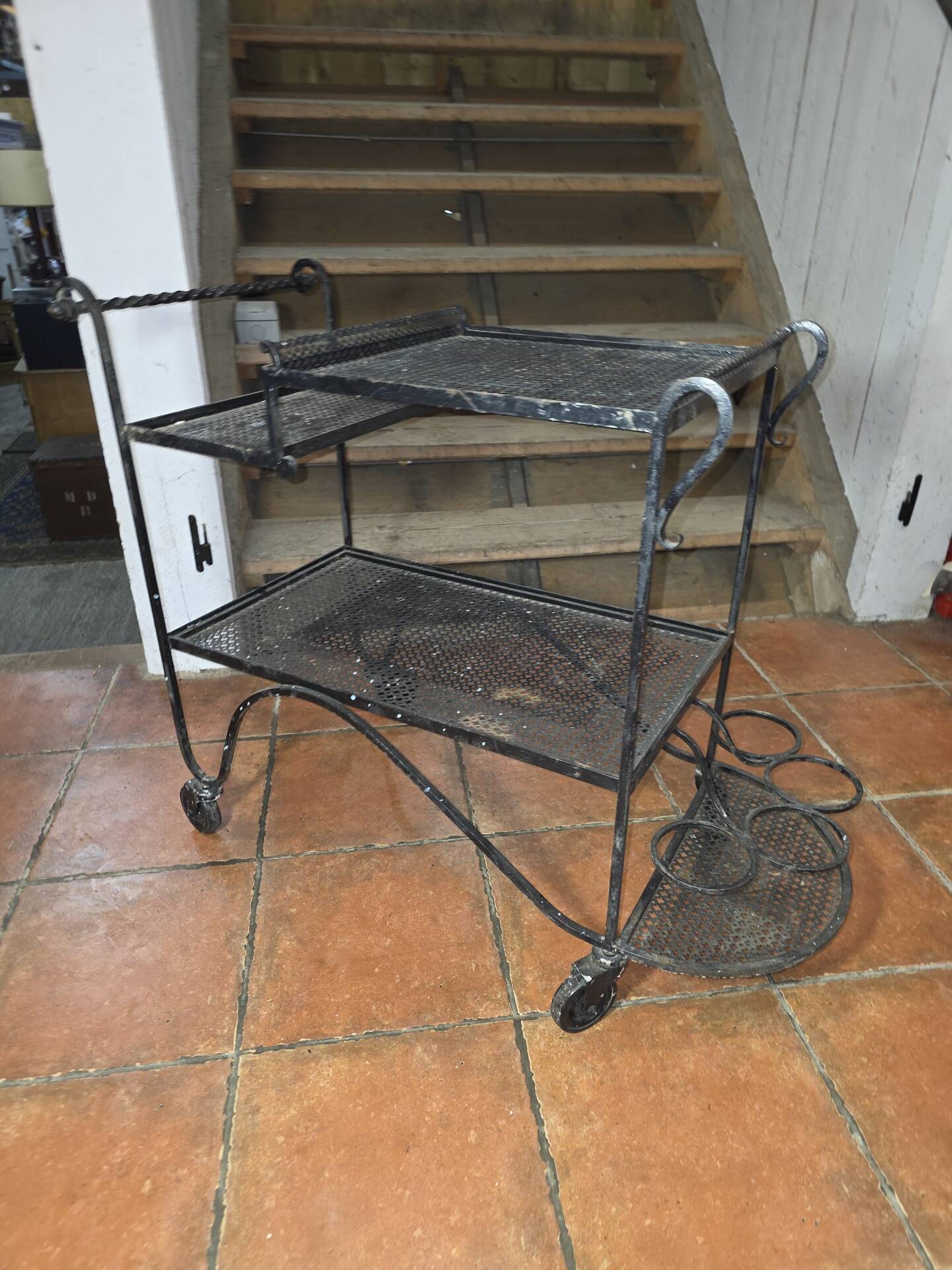 Perforated wrought iron rolling dessert trolley