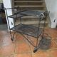 Perforated wrought iron rolling dessert trolley