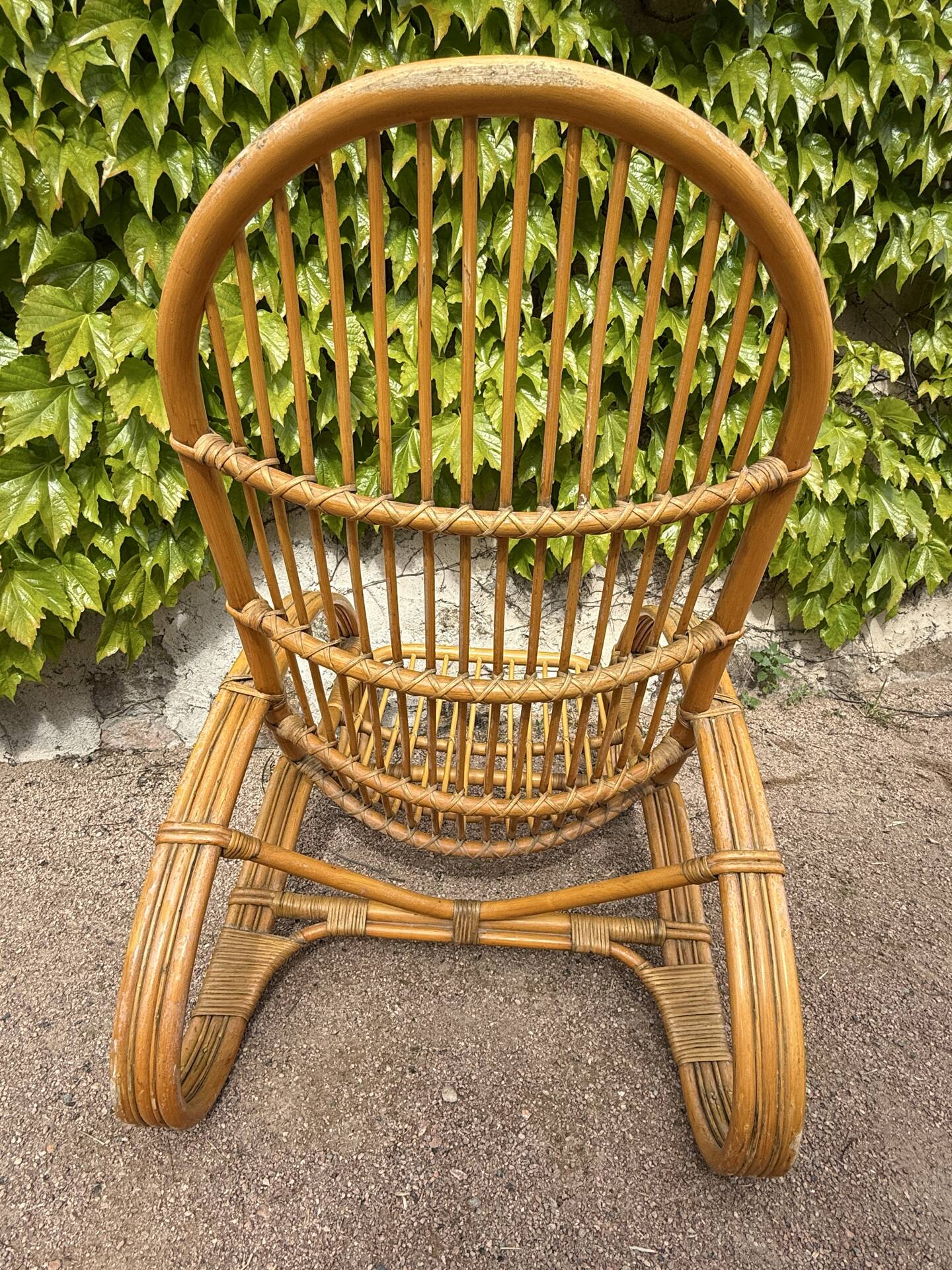 Curved bamboo and rattan armchair in Italian style by Roberti from the 1960s.