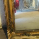 Old mirror with gilded leaves and flowers carved on top of it 1800s