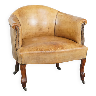 Antique sheep leather club chair/armchair on wheels