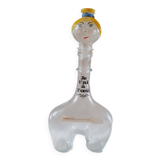 Humorous glass carafe representing a female figure