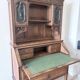 Large secretary with a drop-down front in carved oak, neo-Renaissance style.
