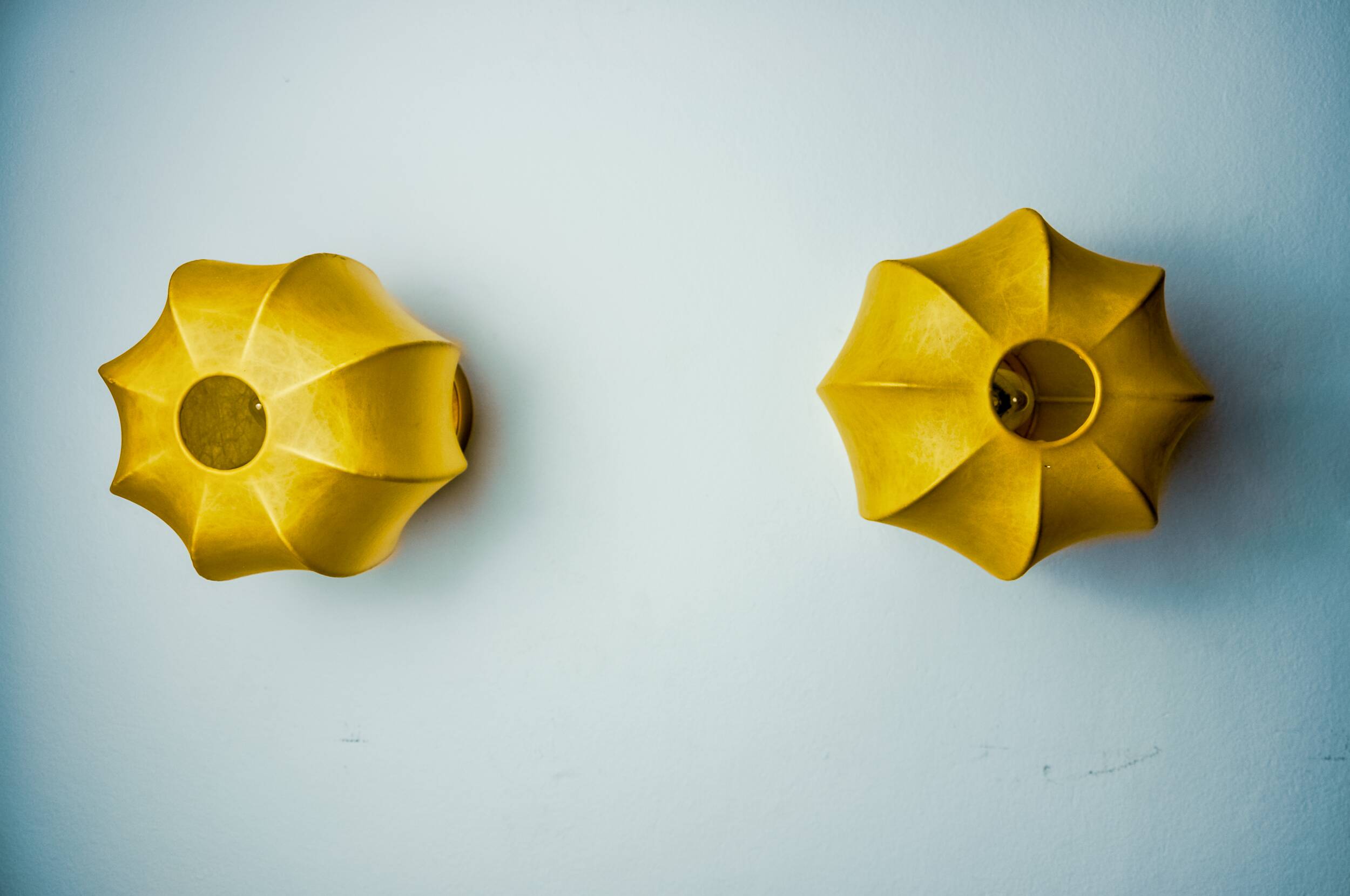 Pair of circular "cocoon" wall lights, resin and pine, Italy, 1970