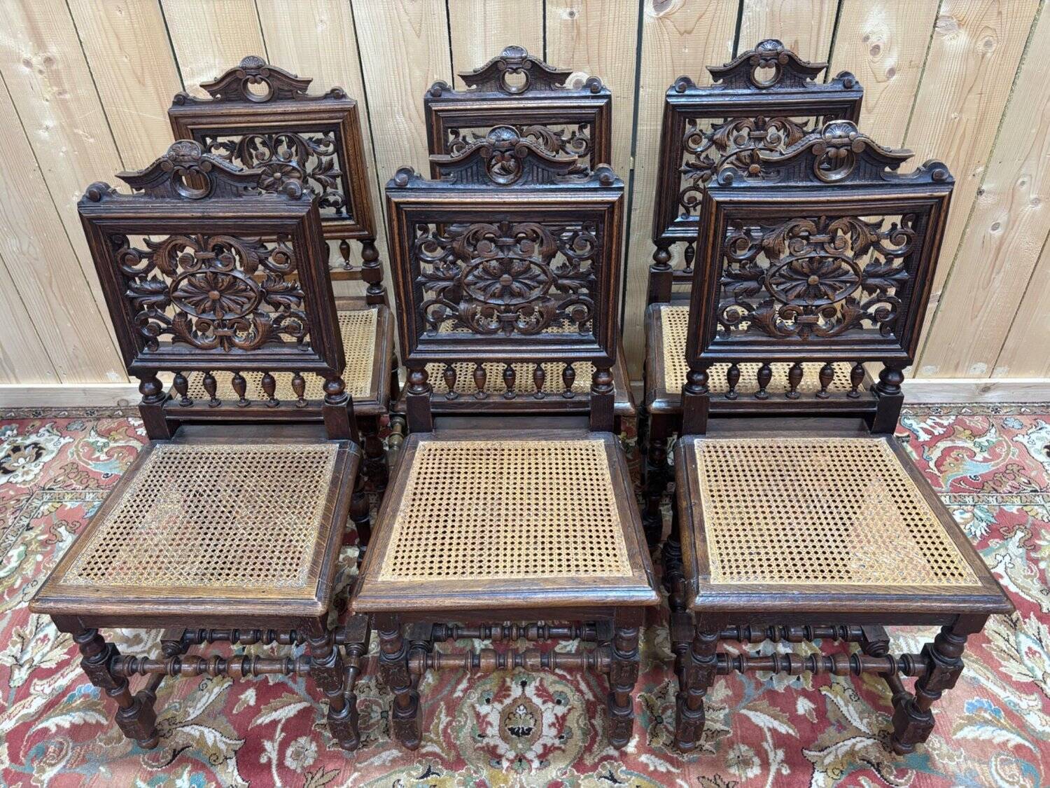 6 High Era chairs in carved solid oak and rattan caning.