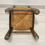Low fireplace chair in the style of Charles Dudouyt – wood and straw seat.