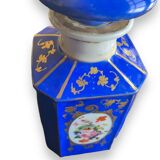 Perfume bottle in porcelain of old paris blue background