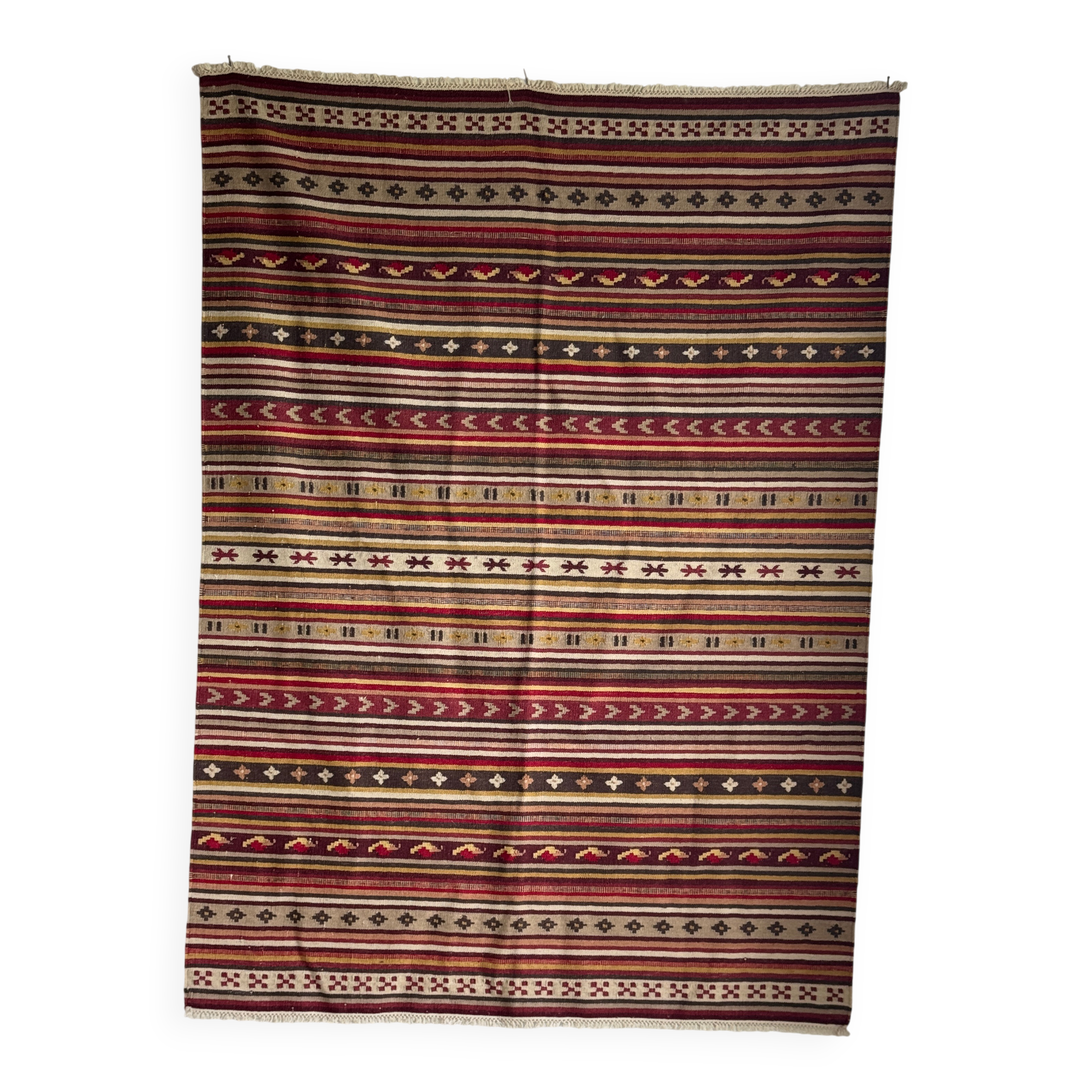 Large Indian rug with red, yellow, and white stripes and geometric fringes.