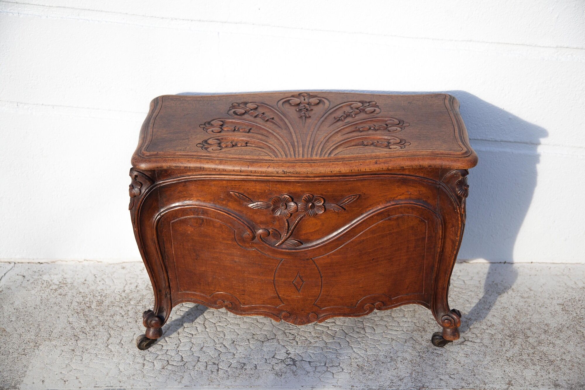 Old chest, carved wooden chest, curved chest on wheels, interior decoration
