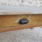Patinated coffee table with a drawer