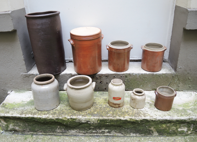 Collection of old sandstone pots with grease and mustard salting