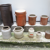 Collection of old sandstone pots with grease and mustard salting